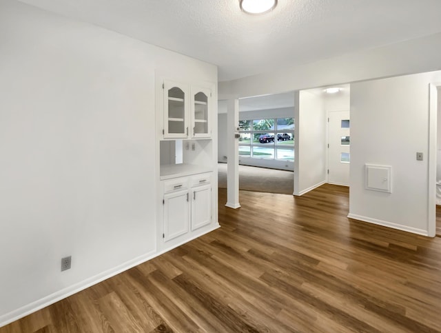 5808 Colfax Ave N, Brooklyn Center, MN 55430 - empty room featuring dark wood-type flooring and a textured ceiling