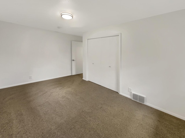 5808 Colfax Ave N, Brooklyn Center, MN 55430 - unfurnished bedroom featuring dark colored carpet and a closet