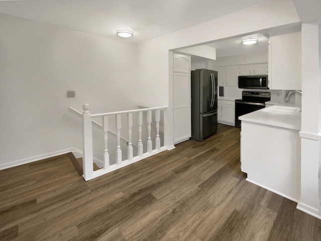 5808 Colfax Ave N, Brooklyn Center, MN 55430 - kitchen with appliances with stainless steel finishes, dark wood-style flooring, white cabinets, and light countertops