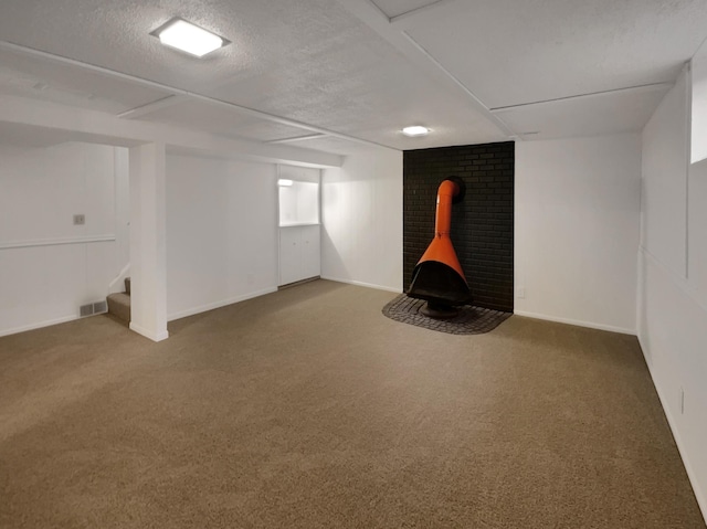 5808 Colfax Ave N, Brooklyn Center, MN 55430 - finished below grade area featuring carpet, stairs, a textured ceiling, and a wood stove