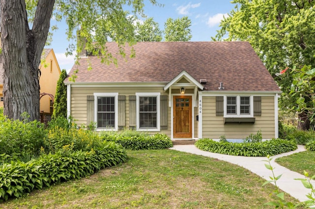 4604 39th St, Saint Louis Park, MN 55416 - cape cod-style house featuring a chimney, a front lawn, and roof with shingles