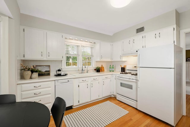 4604 39th St, Saint Louis Park, MN 55416 - kitchen with white appliances, backsplash, under cabinet range hood, and light countertops