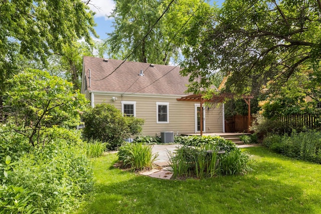 4604 39th St, Saint Louis Park, MN 55416 - rear view of house featuring a lawn, roof with shingles, and a patio area