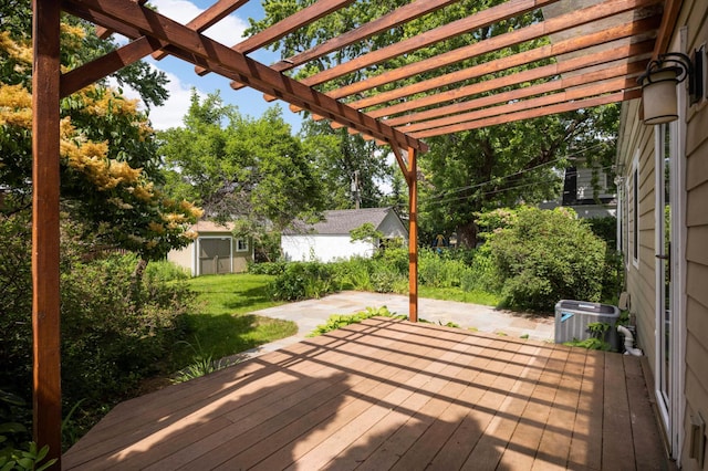4604 39th St, Saint Louis Park, MN 55416 - wooden deck featuring a lawn, a pergola, an outbuilding, and a patio area