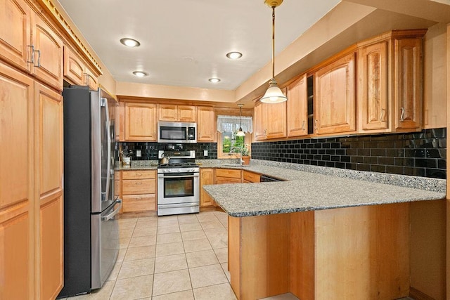 5120 Juniata St, Duluth, MN 55804 - kitchen featuring appliances with stainless steel finishes, a peninsula, decorative backsplash, light tile patterned floors, and decorative light fixtures