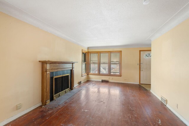 5123 Chicago Ave, Minneapolis, MN 55417 - unfurnished living room featuring a fireplace with flush hearth, hardwood / wood-style flooring, and a textured ceiling