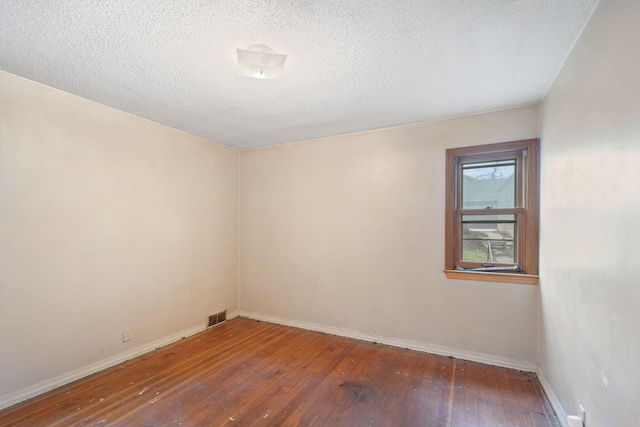 5123 Chicago Ave, Minneapolis, MN 55417 - unfurnished room featuring wood-type flooring and a textured ceiling