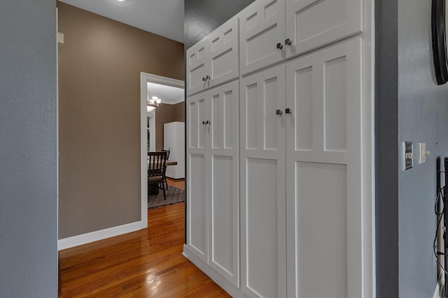 1302 Grizzly Ln, Sartell, MN 56377 - hallway with light wood-style flooring and baseboards