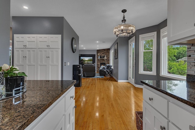 1302 Grizzly Ln, Sartell, MN 56377 - kitchen with white cabinetry, healthy amount of natural light, and decorative light fixtures