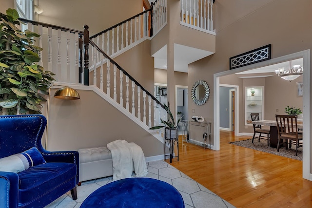 1302 Grizzly Ln, Sartell, MN 56377 - foyer entrance featuring a towering ceiling, wood finished floors, stairway, and a chandelier