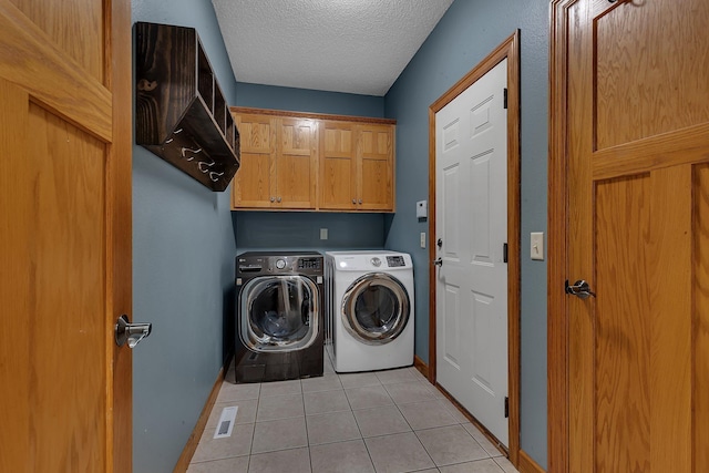 1302 Grizzly Ln, Sartell, MN 56377 - washroom featuring cabinet space, washing machine and clothes dryer, light tile patterned floors, and a textured ceiling