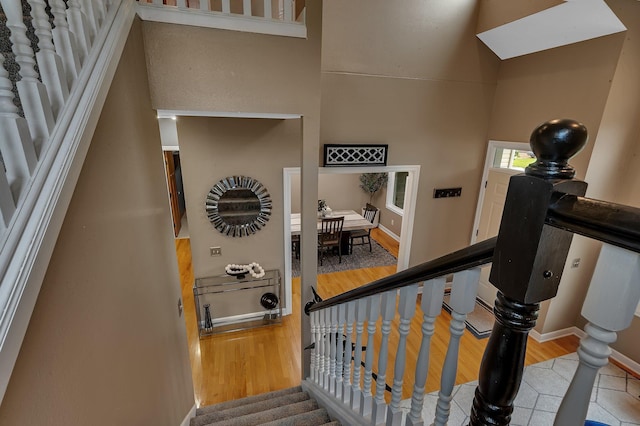 1302 Grizzly Ln, Sartell, MN 56377 - staircase featuring wood finished floors and baseboards
