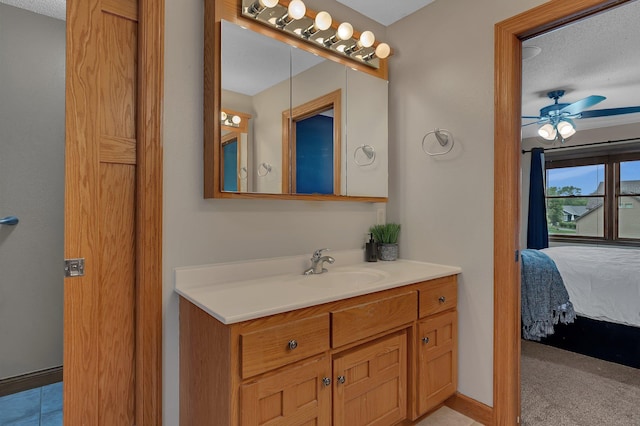 1302 Grizzly Ln, Sartell, MN 56377 - bathroom with ensuite bathroom, vanity, a ceiling fan, and a textured ceiling