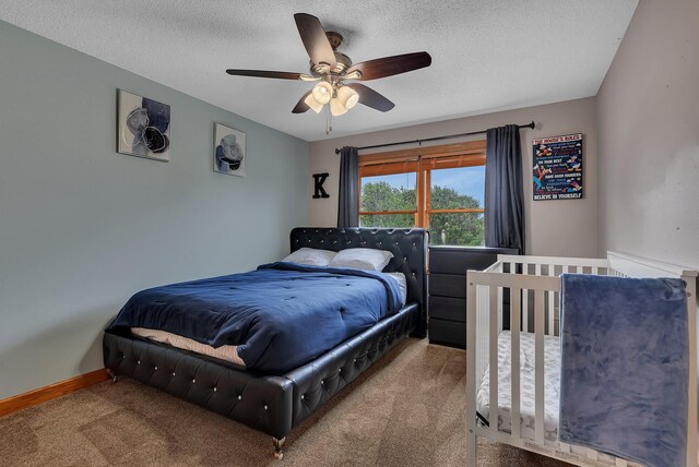 1302 Grizzly Ln, Sartell, MN 56377 - bedroom featuring carpet floors, a textured ceiling, and a ceiling fan