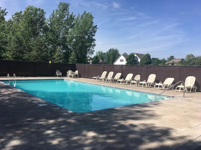 1302 Grizzly Ln, Sartell, MN 56377 - community pool featuring a patio