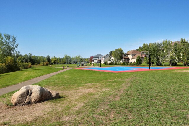 1302 Grizzly Ln, Sartell, MN 56377 - view of home's community with community basketball court and a lawn
