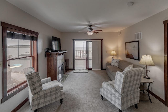 502 Cleveland Blvd Unit 3200, Walker, MN 56484 - living room featuring plenty of natural light, a fireplace with flush hearth, carpet, and ceiling fan
