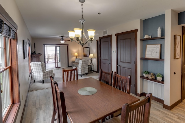 502 Cleveland Blvd Unit 3200, Walker, MN 56484 - dining area featuring a chandelier, light wood-style floors, and a ceiling fan