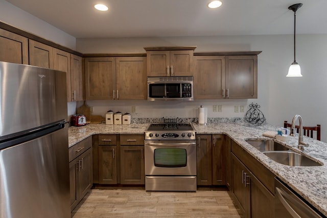 502 Cleveland Blvd Unit 3200, Walker, MN 56484 - kitchen featuring appliances with stainless steel finishes, recessed lighting, light wood-style floors, hanging light fixtures, and light stone countertops