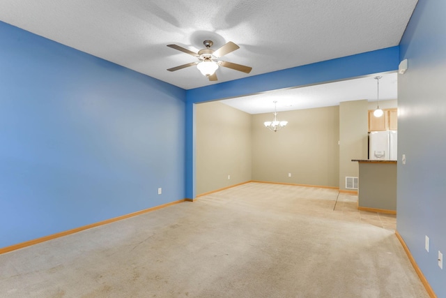 15652 Emerald Dr N Unit 3, Hugo, MN 55038 - empty room featuring ceiling fan, light colored carpet, a chandelier, and a textured ceiling