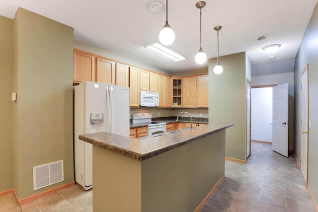 15652 Emerald Dr N Unit 3, Hugo, MN 55038 - kitchen featuring white appliances, dark countertops, light brown cabinetry, glass insert cabinets, and a kitchen island with sink