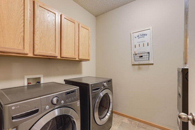 15652 Emerald Dr N Unit 3, Hugo, MN 55038 - washroom featuring cabinet space, washing machine and clothes dryer, a textured ceiling, and light tile patterned floors