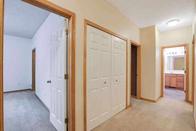 15652 Emerald Dr N Unit 3, Hugo, MN 55038 - hallway with light colored carpet and a textured ceiling