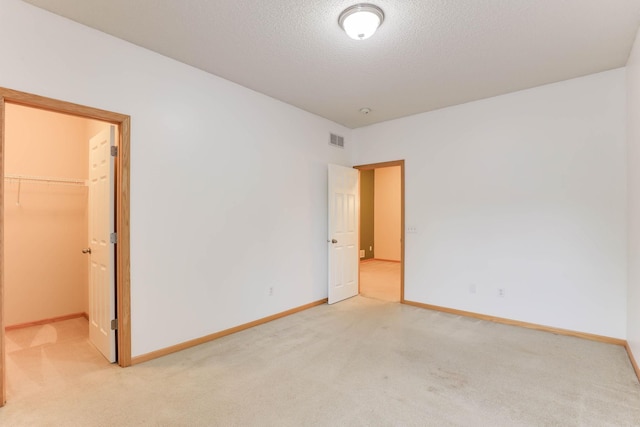15652 Emerald Dr N Unit 3, Hugo, MN 55038 - unfurnished bedroom with light colored carpet, a spacious closet, a closet, and a textured ceiling