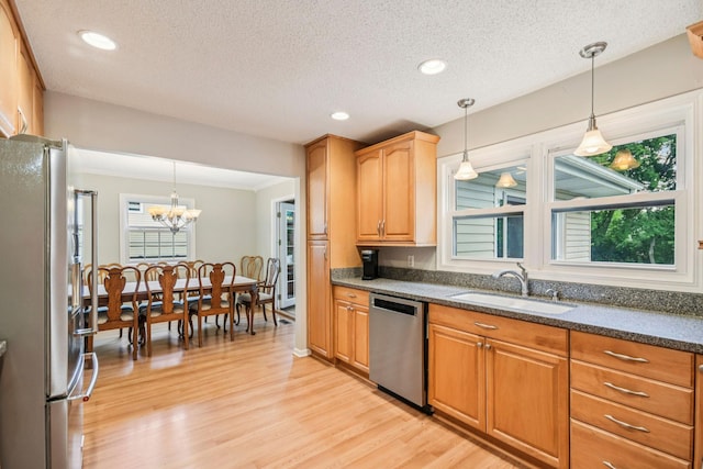 8924 Darnel Rd, Eden Prairie, MN 55347 - kitchen with stainless steel appliances, light wood finished floors, a chandelier, dark stone countertops, and a textured ceiling