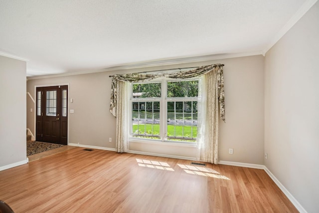 8924 Darnel Rd, Eden Prairie, MN 55347 - spare room featuring ornamental molding, light wood-style flooring, and stairway