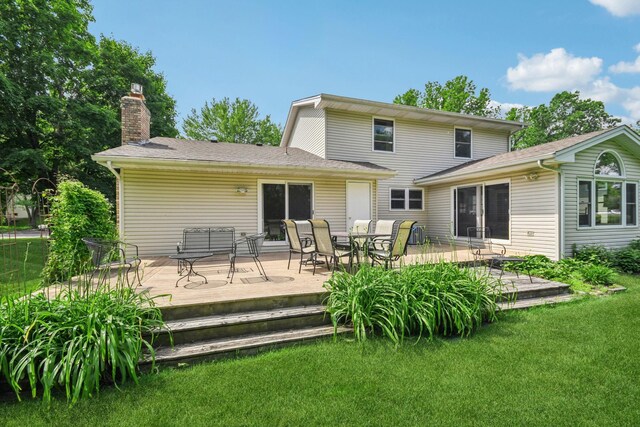 8924 Darnel Rd, Eden Prairie, MN 55347 - rear view of property with a yard, a chimney, outdoor dining space, and a wooden deck