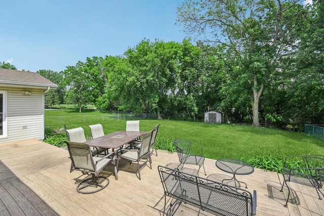 8924 Darnel Rd, Eden Prairie, MN 55347 - wooden deck featuring outdoor dining area, a storage unit, and view of scattered trees