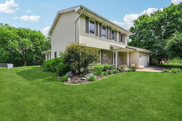 8924 Darnel Rd, Eden Prairie, MN 55347 - view of front of property with an attached garage, a front yard, concrete driveway, and stone siding