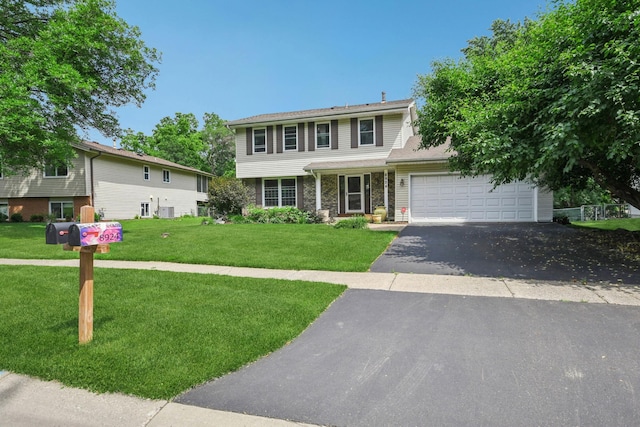 8924 Darnel Rd, Eden Prairie, MN 55347 - view of front of home featuring a front yard, asphalt driveway, and an attached garage
