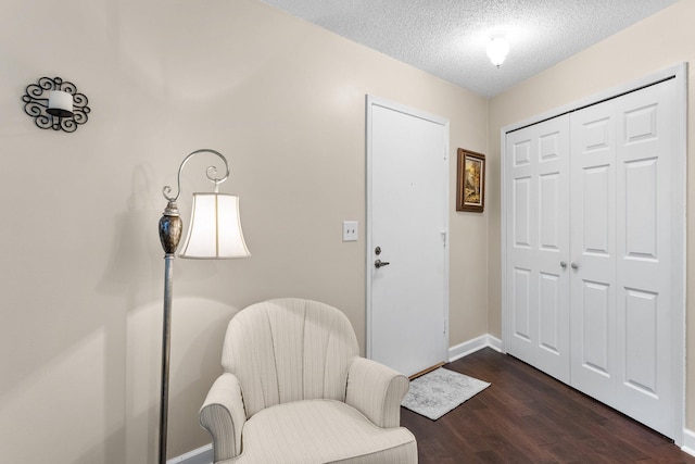 1150 Dellwood St S Unit 306, Cambridge, MN 55008 - sitting room featuring dark wood-type flooring and a textured ceiling