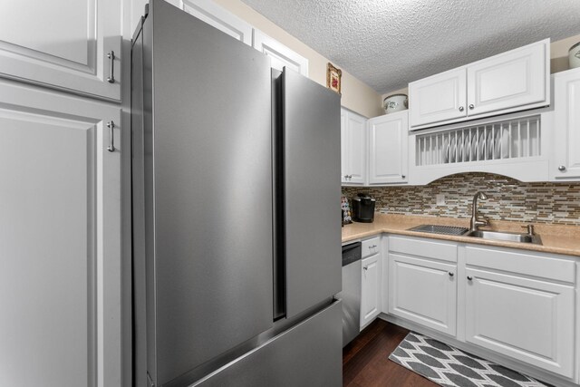 1150 Dellwood St S Unit 306, Cambridge, MN 55008 - kitchen with appliances with stainless steel finishes, white cabinets, a textured ceiling, light countertops, and decorative backsplash