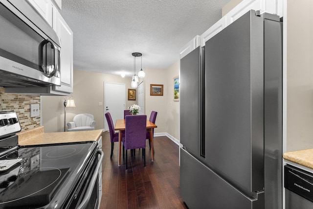 1150 Dellwood St S Unit 306, Cambridge, MN 55008 - kitchen with stainless steel appliances, decorative backsplash, dark wood finished floors, white cabinetry, and light countertops