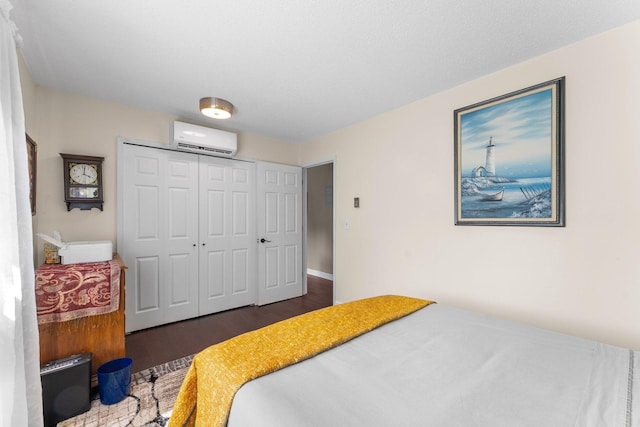 1150 Dellwood St S Unit 306, Cambridge, MN 55008 - bedroom featuring a wall mounted air conditioner, wood finished floors, and a closet