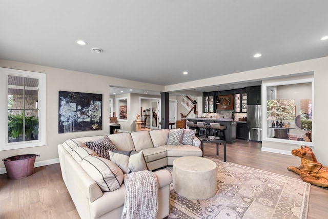 1595 Locust Hills Cir, Wayzata, MN 55391 - living area with bar, dark wood finished floors, recessed lighting, and decorative columns
