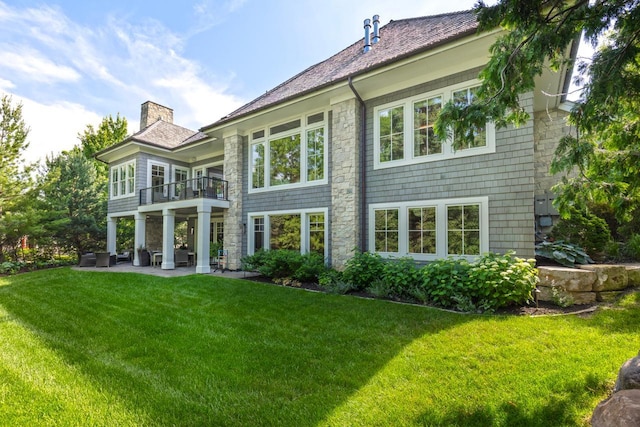 1595 Locust Hills Cir, Wayzata, MN 55391 - back of house featuring a balcony, outdoor lounge area, a yard, a chimney, and a patio