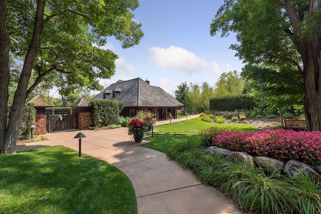 1595 Locust Hills Cir, Wayzata, MN 55391 - view of community featuring a gate and a yard