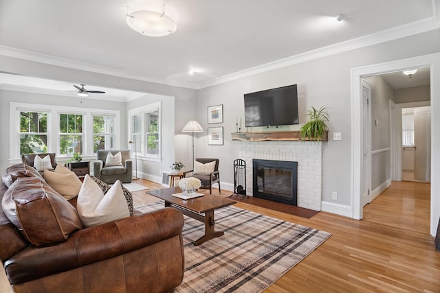 1511 Branston St, Saint Paul, MN 55108 - living room featuring light wood-style floors, a brick fireplace, healthy amount of natural light, crown molding, and a ceiling fan