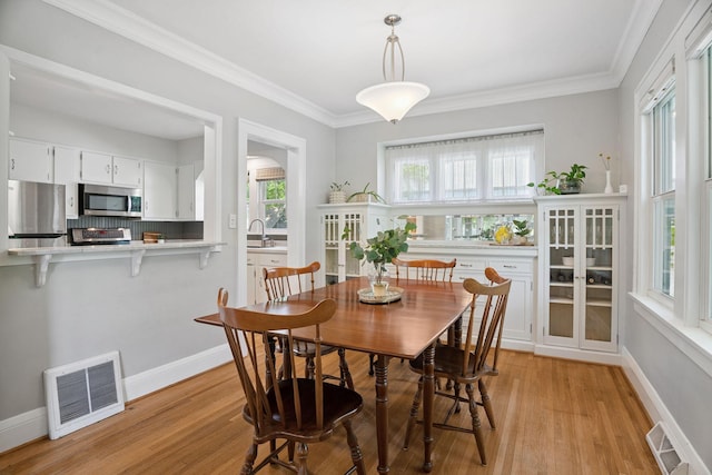 1511 Branston St, Saint Paul, MN 55108 - dining room with light wood-type flooring and crown molding