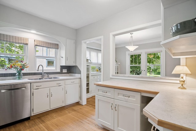 1511 Branston St, Saint Paul, MN 55108 - kitchen featuring dishwasher, light countertops, white cabinets, light wood-type flooring, and healthy amount of natural light