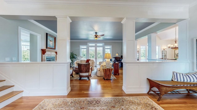 830 Prairie Island Rd N, Winona, MN 55987 - entrance foyer with ornate columns, a decorative wall, ornamental molding, wood finished floors, and a ceiling fan