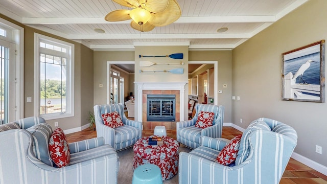 830 Prairie Island Rd N, Winona, MN 55987 - tiled living room featuring a fireplace, a wood ceiling with exposed beams, and a ceiling fan