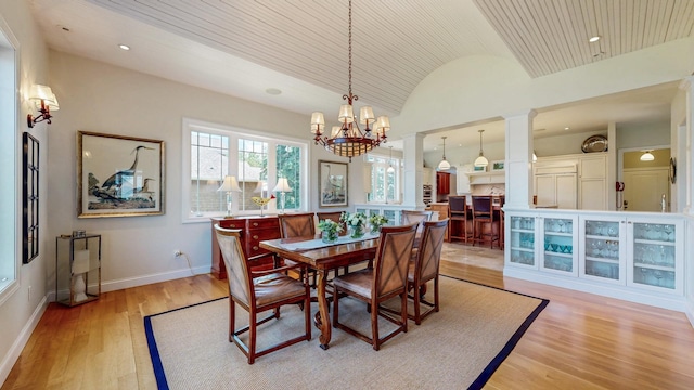 830 Prairie Island Rd N, Winona, MN 55987 - dining space featuring vaulted ceiling, light wood-style floors, a chandelier, decorative columns, and recessed lighting