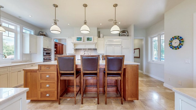 830 Prairie Island Rd N, Winona, MN 55987 - kitchen with light countertops, a breakfast bar area, hanging light fixtures, a center island, and recessed lighting