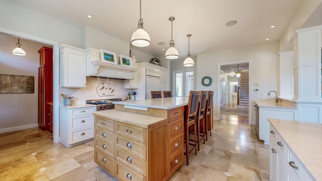 830 Prairie Island Rd N, Winona, MN 55987 - kitchen featuring a kitchen bar, light countertops, decorative backsplash, a center island, and premium range hood