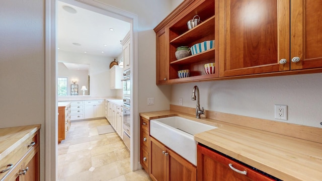830 Prairie Island Rd N, Winona, MN 55987 - kitchen featuring butcher block counters, open shelves, stainless steel oven, brown cabinetry, and recessed lighting